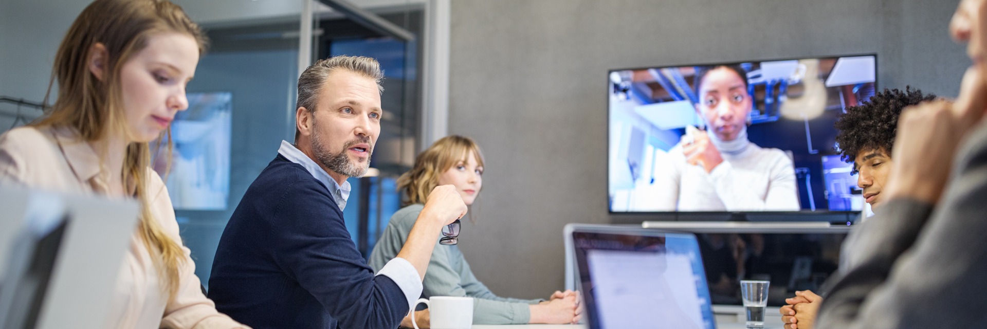 Employees in a hybrid-environment conference room.