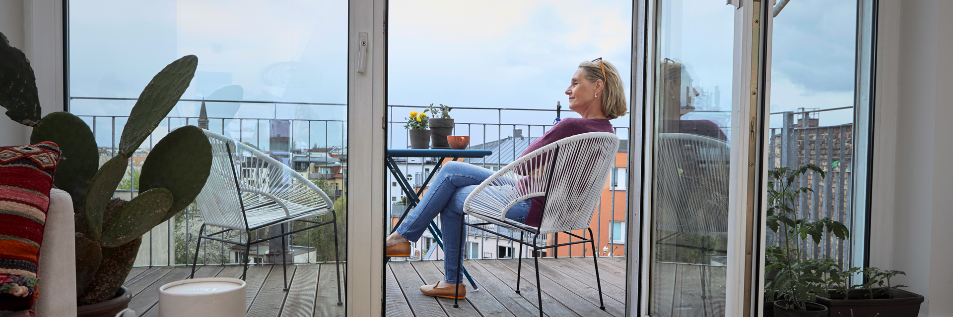 A woman looks out from her patio