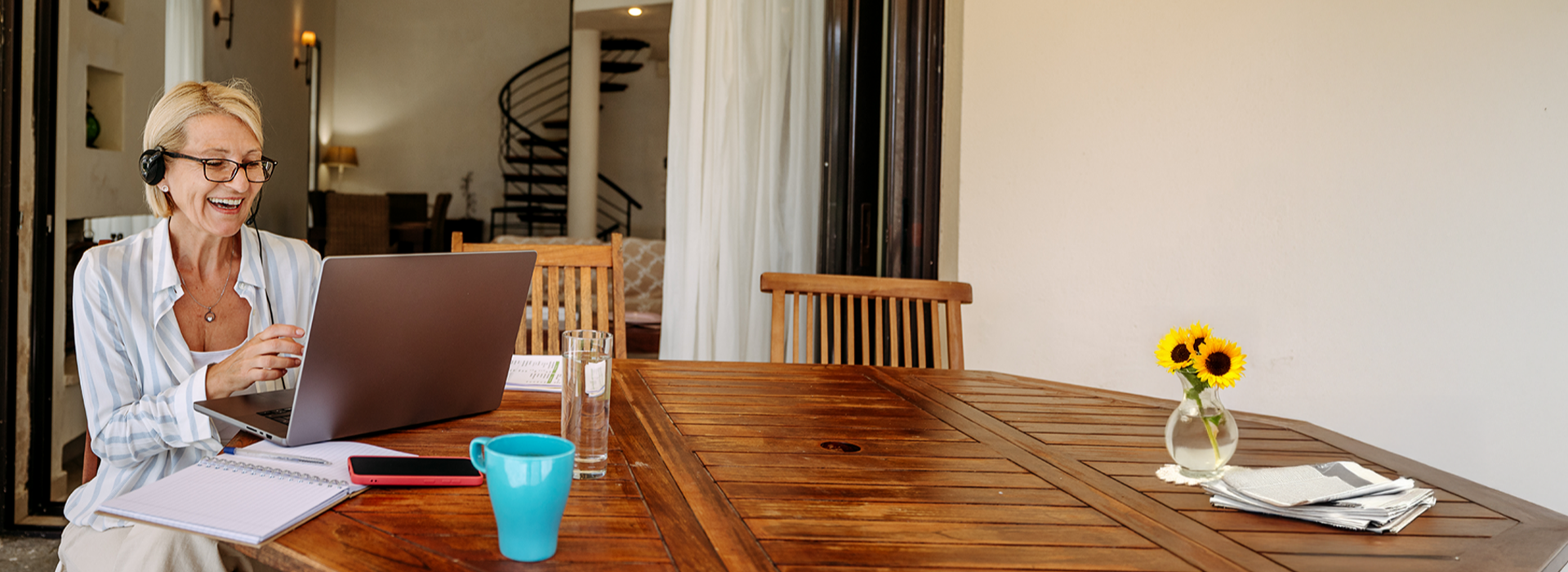 Woman working on laptop while sitting at a table